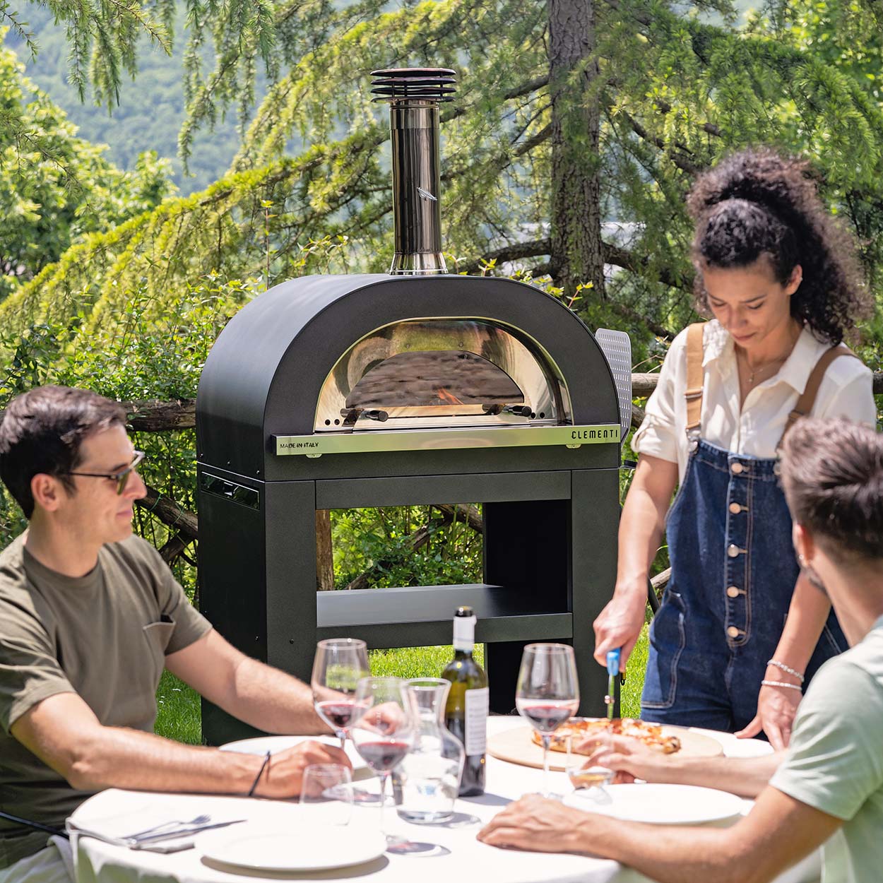 clementi gold wood gas fired pizza oven lifestyle exterior view