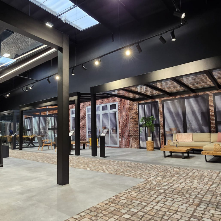 Modern indoor space with industrial design elements, including exposed beams and brick walls.